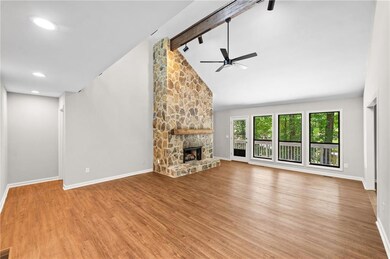 Unfurnished living room with ceiling fan, wood finished floors, a fireplace, and recessed lighting
