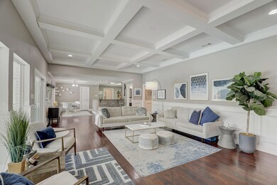 Living Room with a wealth of natural light opens to kitchen