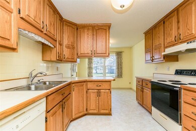 Spacious eat-in kitchen with beveled oak counter t