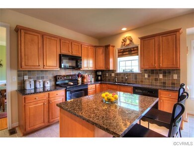 Gourmet kitchen with center island, granite, and a