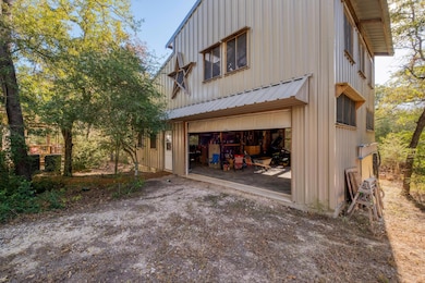 Rear view of house featuring dirt driveway