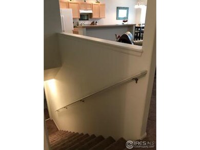 Stairs to basement and view of living room