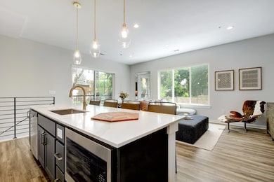 Functional island anchors the kitchen while maintaining sightlines to the living and dining areas.