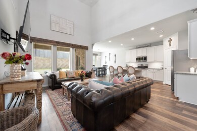 A space for everyone to enjoy, offering gorgeous wood like flooring, large windows fill the wall flooding the space with natural light and you have open site lines straight into to your gorgeous kitchen!