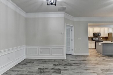 Kitchen featuring visible vents, ornamental moldin