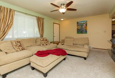 Spacious living room w/large window, neutral carpe