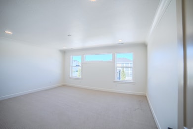 Carpeted empty room with recessed lighting and ornamental molding