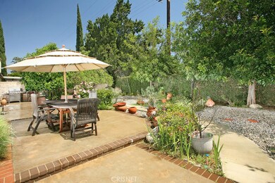 The large backyard will be a favorite entertainment destination with its abundant shade trees, colorful flower beds and combination brick and concrete patio with BBQ area.