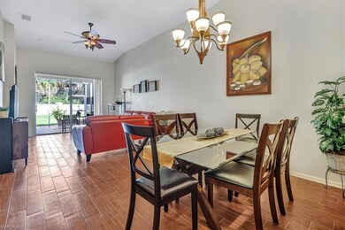 Dining area with wood-type flooring, vaulted ceili
