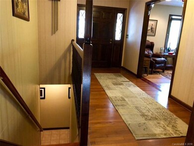 Entry foyer to the right, open stair case to the lower level to the left.