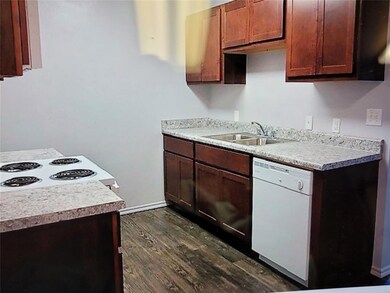 Kitchen featuring dark wood-style flooring, light 