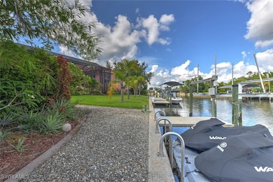 Dock area with a water view and a yard