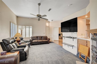 Living room featuring light colored carpet and ceiling fan