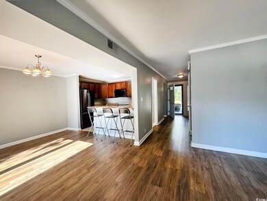 Kitchen featuring an inviting chandelier, crown mo