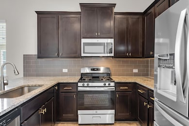 Kitchen featuring stainless steel appliances, a s