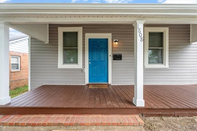 Entrance to property featuring covered porch