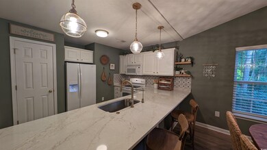 Kitchen featuring white cabinets, decorative backs