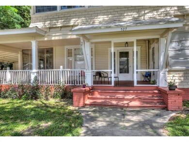 A quaint front porch welcomes you to the property.