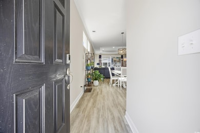 Entryway featuring baseboards and light wood-type flooring