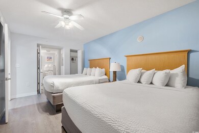 Bedroom with ceiling fan and wood-type flooring