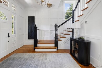 Entrance foyer with a chandelier, wood-type floori
