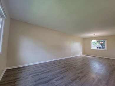 Bright living and dining area with a wide picture