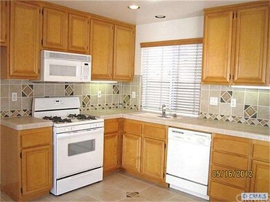 KITCHEN WITH UPGRADED TILE COUNTERS AND BACKSPLASH