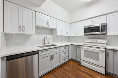 Updated kitchen with new cabinets, stylish backsplash, granite countertops, and stainless steel appliances for a modern, polished look.