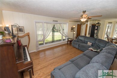 large living room with floor to ceiling windows.