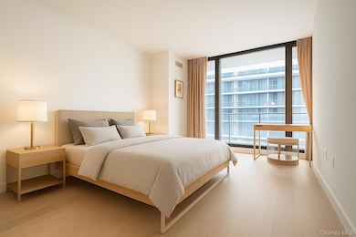 Bedroom with expansive windows and light wood-style flooring
