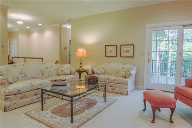 Living room view to entrance way and deck