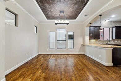 Dining room showcases an ornate wood ceiling with