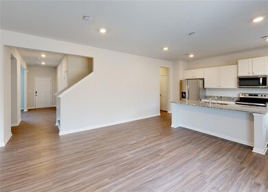 Kitchen with sink, light stone countertops, light 