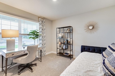 Main floor bedroom or flex room. Photo of Model Home. Options and colors may vary.