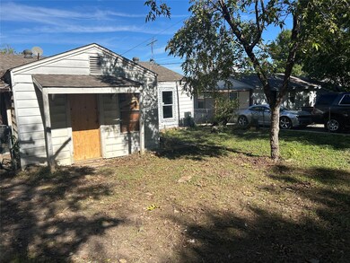 View of front of home with a front lawn and a shed