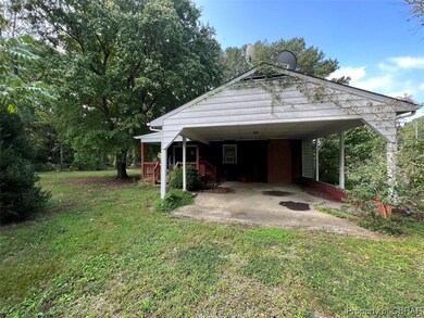 Exterior space with a front yard and a carport