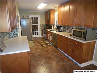 Kitchen features new tile, tile backsplash, under cabinet lights, Quartz counter tops and updated lighting.