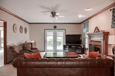 Great room with a fireplace and French doors to th