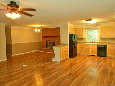 The dining area right next to the kitchen has a gas log fireplace.
