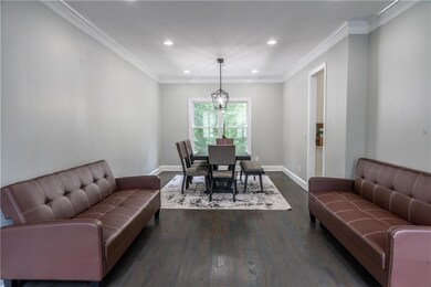 Dining space featuring recessed lighting, dark wood-type flooring, and crown molding