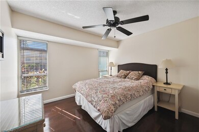 Bedroom with a textured ceiling, ceiling fan, and 