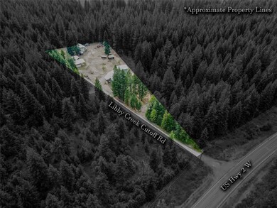 View of property location with a heavily wooded area and property boundaries highlighted