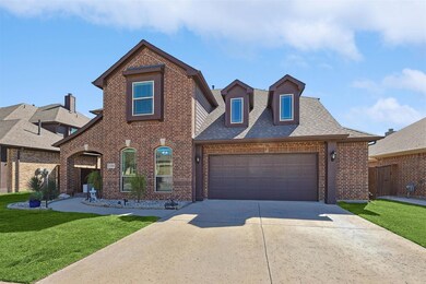 View of front of house with a front lawn and a garage