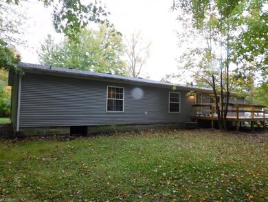 Back of house featuring a yard and a deck