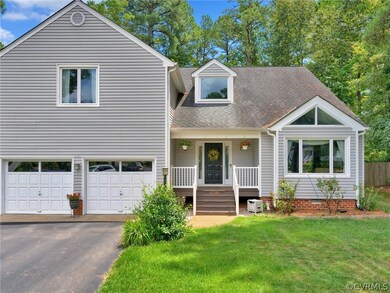 View of front of house with covered porch, a garag