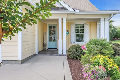 Property entrance with a shingled roof and covered porch