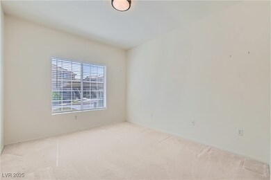 Spare room featuring carpet and baseboards