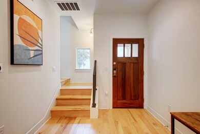 Foyer entrance with stairs, light wood-style floo