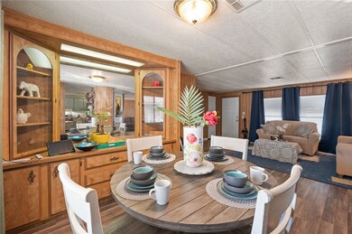 Dining space with wood finished floors and wooden walls