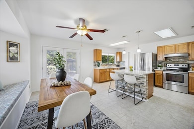 Dining room with ceiling fan and light tile patterned flooring